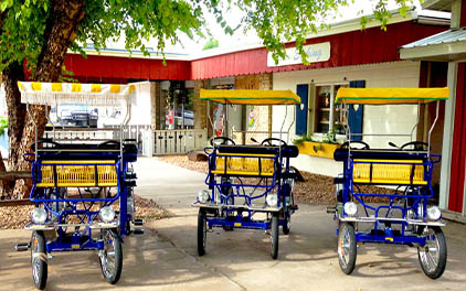 Three quadricycles, four-wheeled bicycles, parted outside of the Hemslöjd.